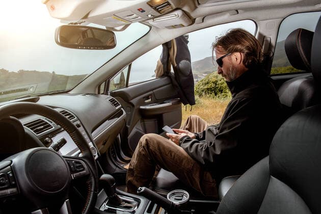 Surfer in car checking phone on coast San Francisco, CA, United States CR_JARA200103A-248921-01