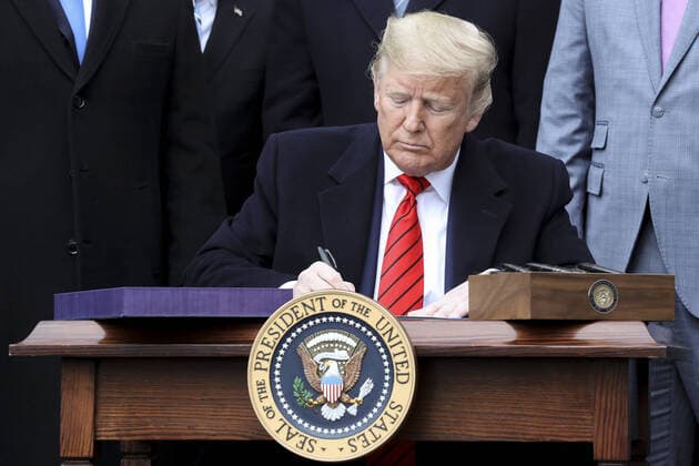 President Donald Trump signs a United States-Mexico-Canada Trade Agreement on the South Lawn of the White House during a ceremony on January 29, 2020 in Washington, DC.  WAX20200129101 OliverxContreras