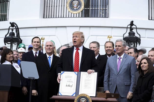 President Donald Trump holds a signed United States-Mexico-Canada Trade Agreement on the South Lawn of the White House on Wednesday, January 29, 2020 in Washington, DC. Next to Trump, members of the Cabinet and members of the Congress.  WAX20200129202 OLIVERxCONTRERAS