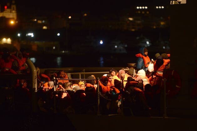 (200130) -- FLORIANA, Jan. 30, 2020 -- Migrants wait to disembark in Floriana, Malta, on Jan. 29, 2020. Seventy-seven migrants rescued by the humanitarian vessel Alan Kurdi were brought to Malta Wednesday evening, after an EU-wide agreement was reached for the redistribution of a total of 477 migrants rescued in the Mediterranean Sea. (Photo by Xinhua) MALTA-FLORIANA-MIGRANTS JonathanxBorg 