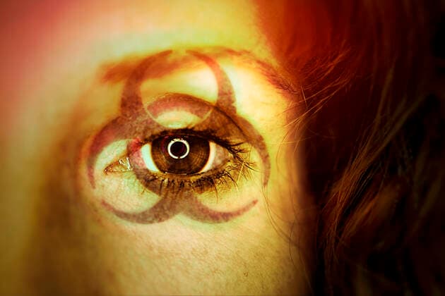 PHOTOMONTAGE, biohazard sign in the face of a woman, symbol photo coronavirus ** NUR FUER REDAKTIONELLE ZWECKE ** EDITORIAL USE ONLY **