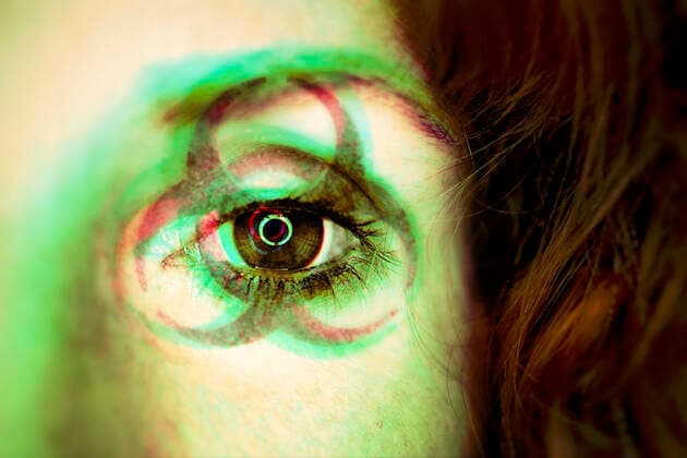 PHOTOMONTAGE, biohazard sign in the face of a woman, symbol photo coronavirus ** NUR FUER REDAKTIONELLE ZWECKE ** EDITORIAL USE ONLY **
