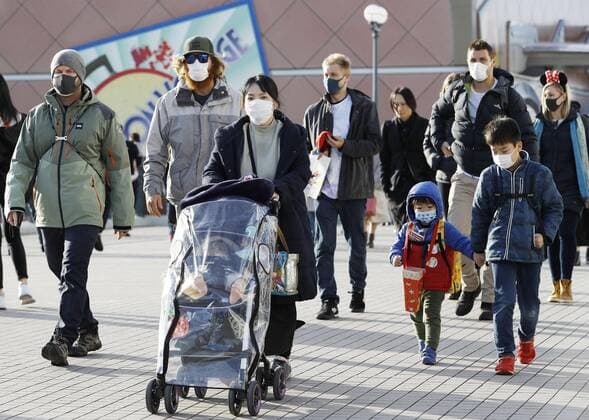 New coronavirus People wear masks near Tokyo Disneyland in Urayasu, eastern Japan, on Feb. 2, 2020, amid the spreading new coronavirus. 