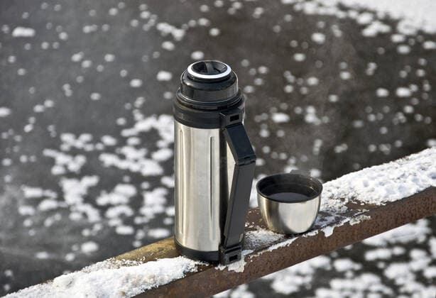 Metal thermos Metal thermos with hot tea drink. Winter.  Copyright: xOledjiox 1430546