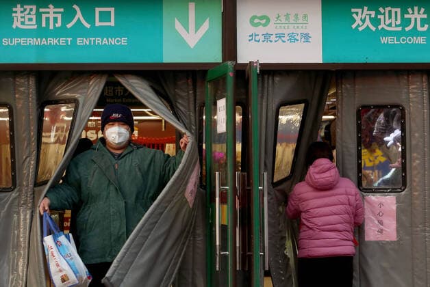 Chinese wear protective face masks while shopping at a supermarket as the deadly coronavirus threatens Beijing on Saturday, February 8, 2020. The virus killed 86 people in a single day in China on Friday. The death toll stands at 724 people, 722 in China, and has infected more than 34,400 people across 27 countries. Face masks are now required in public spaces in the capital.  PEK2020020826 STEPHENxSHAVER