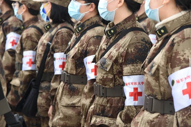 (200213) -- WUHAN, Feb. 13, 2020 -- Military medics arrive at Tianhe International Airport in Wuhan, central China s Hubei Province, Feb. 13, 2020. Ordered by the Central Military Commission, 11 transport aircraft of the People s Liberation Army Air Force Thursday sent medics and supplies provided by the armed forces to virus-hit Wuhan, capital of Hubei Province. This was the first time for China s domestically developed large transport aircraft Y-20 to take part in non-military action. It was also the first time for the Air Force to send large and medium transport aircraft on active service to carry out urgent air transport tasks on a large scale. ) CHINA-HUBEI-WUHAN-NCP-AIR FORCE-MILITARY MEDICS (CN) LixYun 