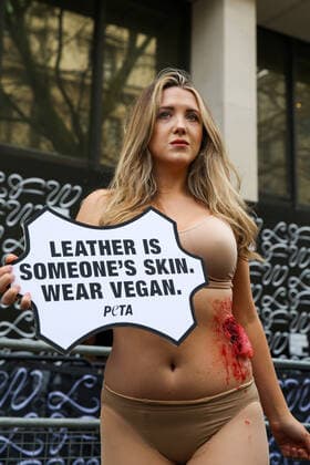 February 14, 2020, London, UK, UK: London, UK. A half naked PETA (People for the Ethical Treatment of Animals) activist holds a sign Leather Is Someone s Skin. Wear Vegan™ during a protest at start of London Fashion Week against the use of animal products in the leather industry. London UK  - ZUMAl94_ 20200214_zaf_l94_039 Copyright: xDinendraxHariax