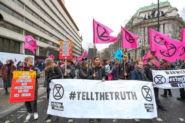February 15, 2020, London, England, United Kingdom: Extinction Rebellion protesters on the Strand, London as part of a protest against London Fashion Week on Saturday, Feb. 15, 2020. (Photo )..Given the ecological consequences of fast fashion and the impact London Fashion Week has on consumption, the organisation says a boycott is the only way forward to help save our planet..In order to get their message across, the activists will be taking part in several protests during the five-day event in London. London United Kingdom - ZUMAx02_ 20200215_zaf_x02_006 Copyright: xVudixXhymshitix