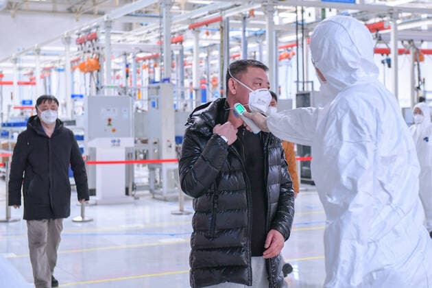 (200217) -- JILIN, Feb. 17, 2020 -- A staff member measures body temperatures of other workers at the engine plant of FAW-Volkswagen Automobile Co., Ltd. in Changchun, northeast China s Jilin Province, Feb. 17, 2020. Companies resumed production with epidemic prevention measures during the outbreak of the novel coronavirus. (Photo by Xinhua) CHINA-CHANGCHUN-FAW-PRODUCTION RESUMPTION (CN) YanxLinyun 