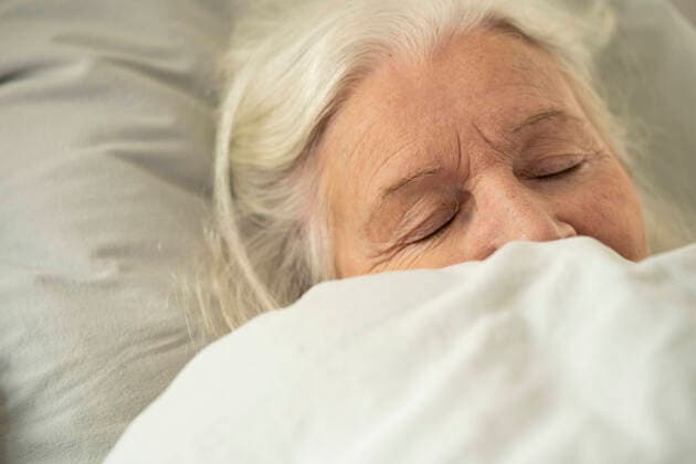 Woman sleeping on bed Copyright: FrédéricxCirou B03399938
