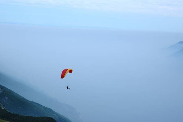 Paragliding in The Alps Paragliding in the misty Alps with mountains scenics  Copyright: xkhwix 341669