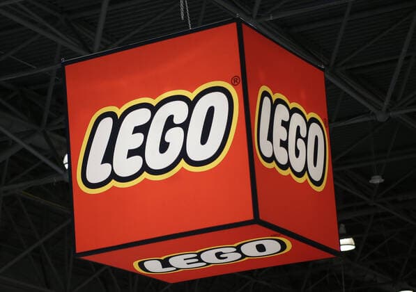 A Lego logo hangs above attendees at 117th American International Toy Fair at the Jacob K. Javits Convention Center in New York City on Saturday, February 22, 2020. This is largest toy and youth product marketplace in the Western Hemisphere, bringing together more than 1,000 exhibiting manufacturers, distributors, importers and sales agents from around the globe to showcase their toy and entertainment products.  NYP20200222107 JOHNxANGELILLO