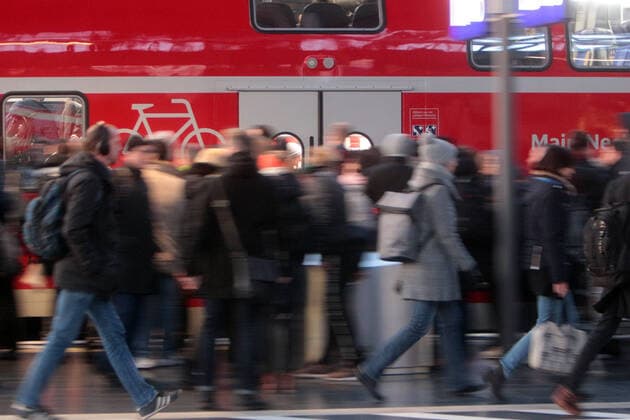 A delayed regional express of DB Deutsche n Bahn arrives at a crowded platform at Frankfurt central station, Hesse, Germany