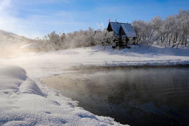 KAMCHATKA TERRITORY, RUSSIA - FEBRUARY 23, 2020: A view of the Khodutka hot springs by Khodutka and Priyomysh Volcanoes in South Kamchatka Nature Park in Yelizovo District on the Kamchatka Peninsula in Russia s Far East. South Kamchatka Nature Park is inscribed on the UNESCO World Cultural and Natural Heritage List; the water in the Khodutka hot springs contains lots of silicic acid, while its temperature reaches 40Â°C. Yuri Smityuk TASS  TS0CF653