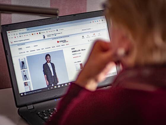 Berlin woman with notebook surfing the Internet, Zalando Berlin