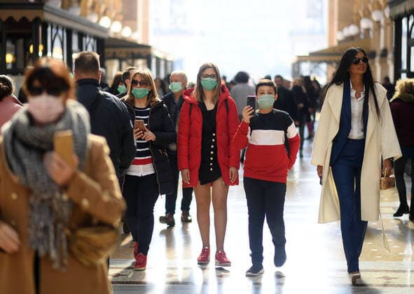 (200224) -- MILAN, Feb. 24, 2020 (Xinhua) -- People wear masks as they walk in Milan, Italy, on Feb. 24, 2020. Six people have died and 222 have tested positive for the novel coronavirus (COVID-19) nationwide in Italy, Angelo Borrelli, chief of Civil Protection Department and Extraordinary Commissioner for the Coronavirus Emergency, told a press conference at 6 p.m. local time on Monday. (Photo by Daniele Mascolo Xinhua) ITALY-MILAN-COVID-19-CONFIRMED CASES-RISE 