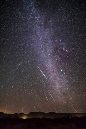 The Geminid meteor shower of December 13, 2017 in a view framing the winter Milky Way from Auriga (at top) to Puppis (at bottom) with Gemini itself, the radiant of the shower at left, and Orion at right. The view is looking southeast to the Peloncillo Mountains in New Mexico though the site at Quailway Cottage is in Arizona, near Portal. This is a composite stack of one base image with the brightest meteor, then 20 other images layered in each with a meteor. The camera was not tracking the sky, so I rotated and moved each of the layered-in frames so that their stars mroe or less aligned with the base layer, to ensure the meteor streak ended up in the correct location with respect to the stars and to the radiant point, illustrating the radiant in Gemini above Castor. The images for this composite were taken over 107 minutes starting Copyright: xAlanxDyerx xVWPicsx ADY-OCT18-231