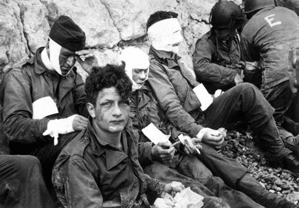 U.S. assault troops of the 16th Infantry Regiment, wounded on Omaha Beach, on D-Day. They wait for evacuation for further medical treatment. Collville-sur-Mer, Normandy, France, June 6, 1944, World War 2. (BSLOC_2014_2_38) Courtesy Everett Collection PUBLICATIONXNOTxINxCANxCHNxFRAxITAxJPNxNORxPOLxRUSxESPxUKxUSA Copyright: xCourtesyxEverettxCollectionx HISL037 EC205