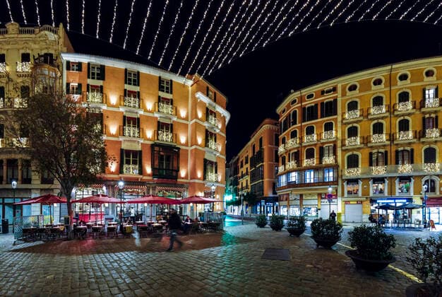 Spain, Balearic Islands, Palma de Mallorca, Buildings and sidewalk cafe illuminated at night  AMF07821