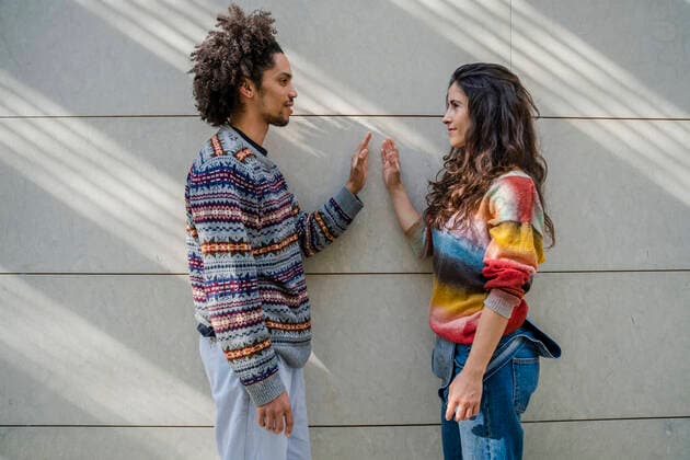 Couple of dancers face to face in front of a wall model released Symbolfoto  DLTSF00516