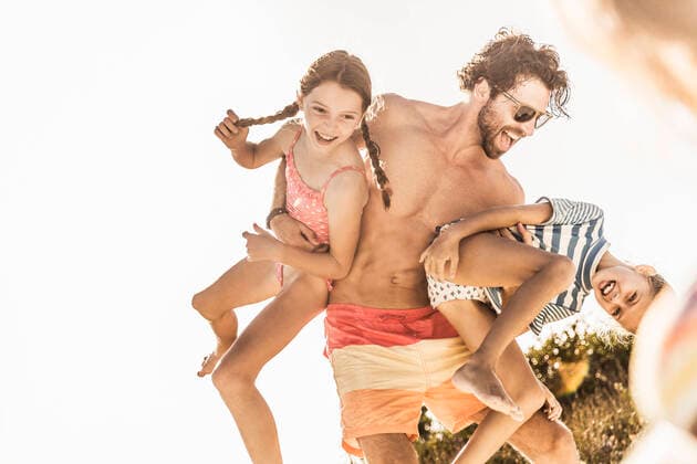 Father having fun with his daughters outdoors in summer model released Symbolfoto property released  SDAHF00118