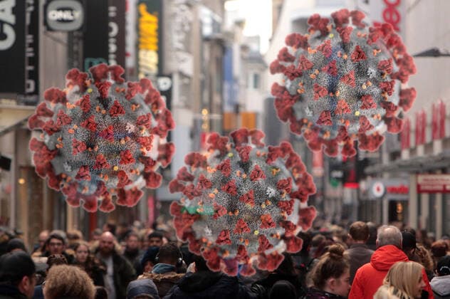 PHOTO MONTAGE Symbol image of the spread of the coronavirus in Germany Virus with crowd of people in the pedestrian zone Hohe Straße in downtown Cologne, North Rhine-Westphalia, Germany