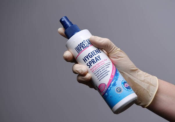 Tuebingen 29 02 2020 Symbol picture One hand with disposable glove and disinfection spray