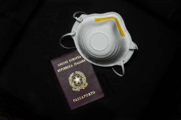 A generic mask that has become a symbol of the fight against Coronavirus (COVID-19) and an Italian passport which is now blocked in many countries of the world. 28 02 2020, Milan, Italy  Copyright: xAlfonsoxDixVincenzox xIPAx xKontrolabx
