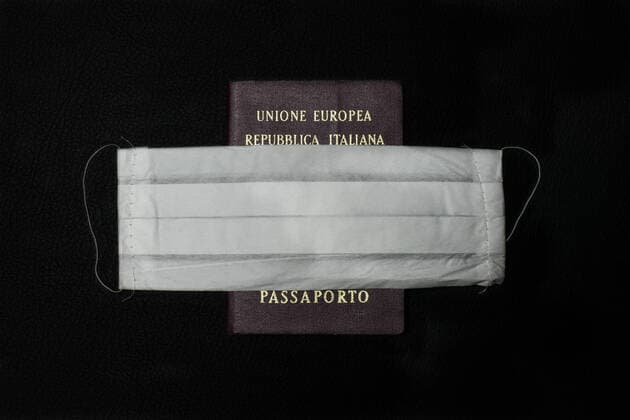 A generic mask that has become a symbol of the fight against Coronavirus (COVID-19) and an Italian passport which is now blocked in many countries of the world. 28 02 2020, Milan, Italy  Copyright: xAlfonsoxDixVincenzox xIPAx xKontrolabx
