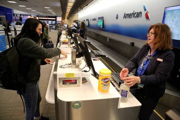 March 2, 2020, Tampa, Florida, USA: American Airlines customer service agent Cindy Warner, right, uses hand sanitizer moments after handling airline passenger Renee Ortiz s drivers license as a countermeasure to coronavirus at the ticketing counter at Tampa International Airport (TIA) on Monday, March 2, 2020, in Tampa. Concern for exposure to coronavirus has become more acute in the wake of the announcement by state health officials that Florida s first coronavirus cases have been found in Hillsborough and Manatee counties..The Hillsborough case is an adult with a travel history to Italy. The Manatee patient is an adult resident without a history of travel to restricted countries. Tampa USA - ZUMAs70_ 20200302_zan_s70_035 Copyright: xDouglasxR.xCliffordx