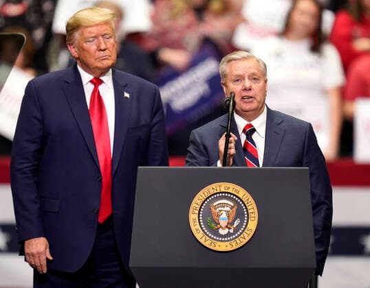 March 2, 2020, Charlotte, North Carolina, USA: United States Senator LINDSEY GRAHAM addresses the crowd as President DONALD TRUMP looks on during a Keep America Great rally at the Bojangles Coliseum in Charlotte, North Carolina on Monday March 2, 2020. 14 states and American Samoa will vote or caucus on Tuesday March 3rd. Their ballots will represent over 33 percent of the national primary totals. Charlotte USA - ZUMAj110 20200302_zsp_j110_037 Copyright: xRustyxJonesx