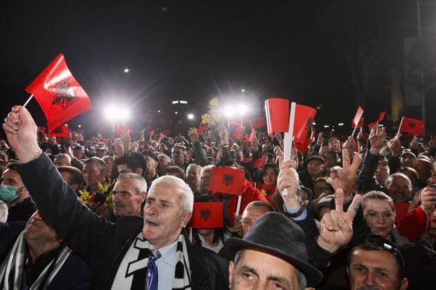 (200303) -- TIRANA, March 3, 2020 (Xinhua) -- Albanian citizens holding Albanian national flags shout slogans during a rally in Tirana, Albania, on March 2, 2020. Thousands of people joined here on Monday in an anti-government rally in support of President Ilir Meta, who accused the ruling majority of Socialist Party of Prime Minister Edi Rama of violating the country s constitution. (Photo by Arben Celi Xinhua) ALBANIA-TIRANA-RALLY 