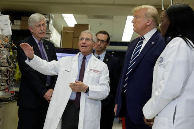 Director of the National Institute of Allergy and Infectious Diseases at the National Institutes of Health Dr. Anthony Fauci (wearing a colleague s lab coat) speaks as United States President Donald J. Trump tours the Viral Pathogenesis Laboratory at National Institutes of Health n Vaccine Research Center in Bethesda, Maryland on March 3, 2020. At left is Dr. Francis Collins, Director, National Institutes of Health (NIH). Copyright: xYurixGripasx