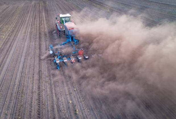 Agrarfoto Aerial photograph, agricultural machinery in operation during severe drought Maize cultivation with heavy dust generation Aerial photograph of a tractor with maize planter in operation District of Osnabrück Lower Saxony Germany