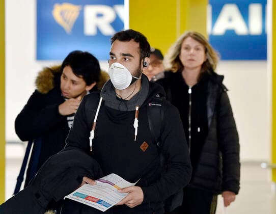 The last flight from Bergamo, Italy, by the aircraft of the Ryanair low-cost airlines, arrived in Brno, Czech Republic, on March 4, 2020. After this landing it will not fly for at least two weeks and it will be up to the government to decide on when it will renew the ban on flights from the Italian centre of the novel coronavirus in Europe. On the photo is seen a passenger with a face mask after arrive. (CTKxPhoto VaclavxSalek) CTKPhotoP202003040497201 _SAL7111