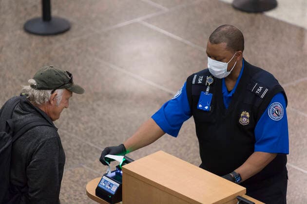 March 6, 2020, Seatac, Washington, U.S: A TSA agent wearing a surgical mask screens a passenger at a security checkpoint in the Central Terminal at Seattle-Tacoma International Airport on March 6, 2020. The Port of Seattle is working to prevent to spread of coronavirus with elevated hygiene protocols and the staffing of public health employees who proactively monitor for signs passengers who present signs of illness. Seatac U.S. - ZUMAg235 20200306_zap_g235_007 Copyright: xPaulxChristianxGordonx