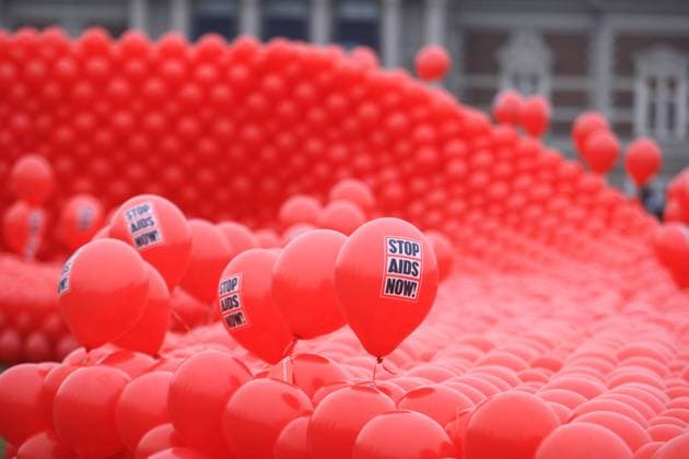 Red ribbon of the Dutch organization STOP AIDS NOW during an awareness campaign to mark World AIDS Day at Museumplein in Amsterdam,Netherlands. Amsterdam Netherlands Copyright: xPauloxAmorimx PA01122014_001
