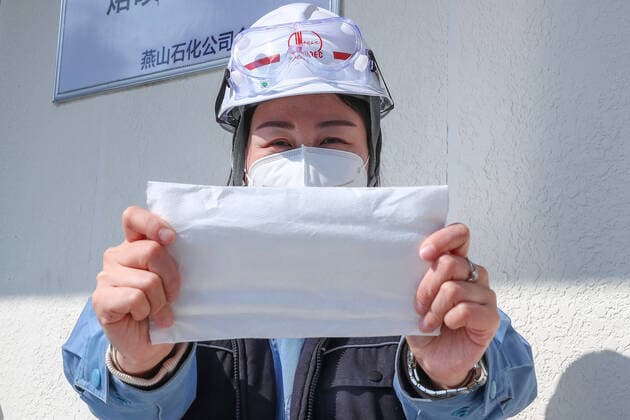 (200308) -- BEIJING, March 8, 2020 -- A technician shows a piece of melt-blown fabrics, a key material in making masks, at a plant in Fangshan District of Beijing, capital of China, March 7, 2020. With a designed annual production capacity of 14,400 tons, the melt-blown fabrics production line of Yanshan petrochemical company in Beijing, was built to boost the production of masks amid the fight against the novel coronavirus. ) BEIJING-MELT-BLOWN FABRIC-PRODUCTION (CN) ZhangxYuwei