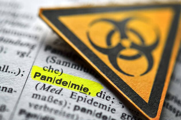 The word pandemic in the dictionary and biohazard signs, symbol photo Corona crisis ** NUR FUER REDAKTIONELLE ZWECKE ** EDITORIAL USE ONLY **