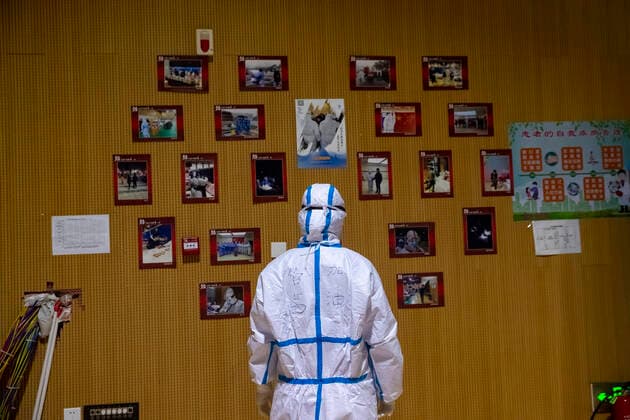 (200310) -- WUHAN, March 10, 2020 -- Medical worker Guan Qian looks at photos of patients and medical staff members pasted at a temporary hospital converted from Hongshan Gymnasium in Wuhan, central China s Hubei Province, March 9, 2020. Wuhan, the epicenter of the novel coronavirus outbreak in central China s Hubei Province, is expected to suspend the last two temporary hospitals remaining in operation on Tuesday as the number of COVID-19 patients continued to drop in the city. ) CHINA-HUBEI-WUHAN-TEMPORARY HOSPITAL-CLOSING(CN) ShenxBohan 