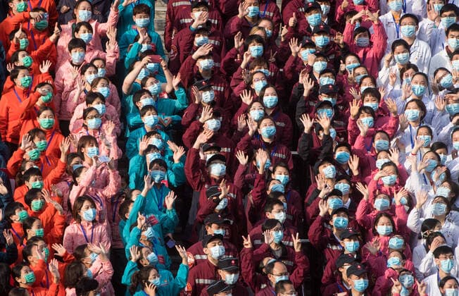 (200310) -- WUHAN, March 10, 2020 -- Medical workers wave to celebrate after the closure of a temporary hospital in Wuchang District of Wuhan, central China s Hubei Province, March 10, 2020. The last two temporary hospitals in Wuhan, the epicenter of the coronavirus outbreak in central China s Hubei Province, were shut down Tuesday, marking the closure of all 16 temporary hospitals in the city. ) CHINA-WUHAN-TEMPORARY HOSPITALS-CLOSURE (CN) XiaoxYijiu 