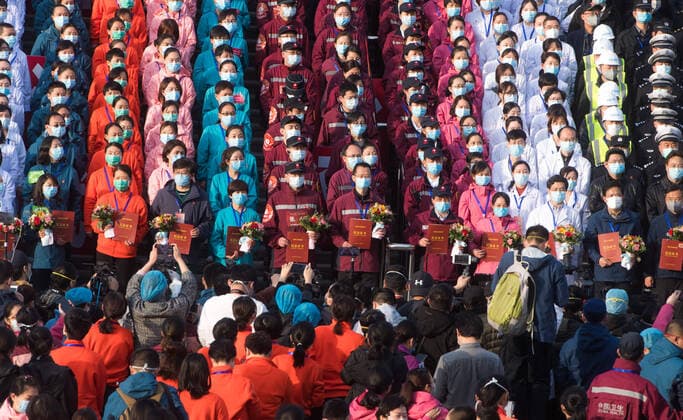(200310) -- WUHAN, March 10, 2020 -- Medical workers are awarded the certificates of commemoration after the closure of a temporary hospital in Wuchang District of Wuhan, central China s Hubei Province, March 10, 2020. The last two temporary hospitals in Wuhan, the epicenter of the coronavirus outbreak in central China s Hubei Province, were shut down Tuesday, marking the closure of all 16 temporary hospitals in the city. ) CHINA-WUHAN-TEMPORARY HOSPITALS-CLOSURE (CN) XiaoxYijiu 