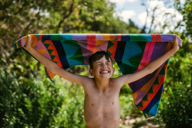 Young boy with towel at beach on summer vacation with a big smile Canada, Ontario, Kincardine ,model released, Symbolfoto CR_KEMA200116D-290614-01