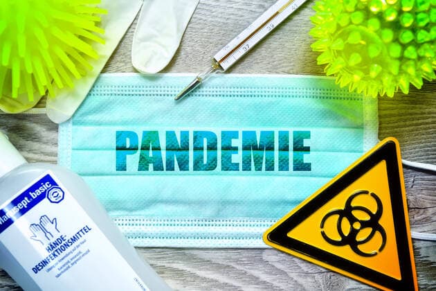PHOTO MOUNTING, face mask with the lettering pandemic, biohazard sign, protective gloves, clinical thermometer and disinfectant on a table, symbol photo coronavirus ** NUR FUER REDAKTIONELLE ZWECKE ** EDITORIAL USE ONLY **
