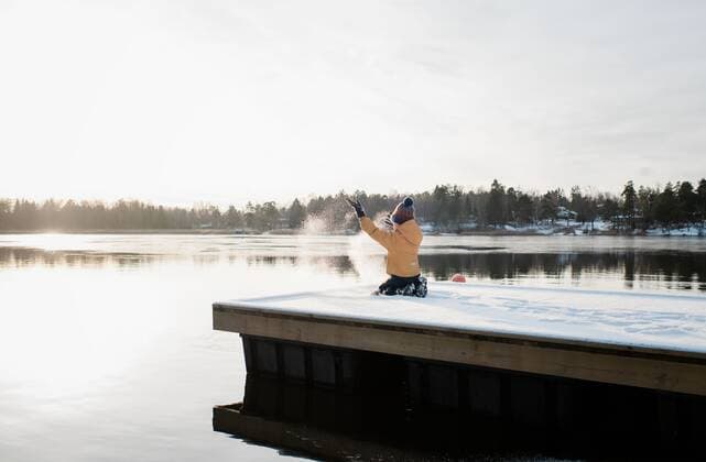 boy throwing snow up in the air whilst playing outside by Baltic sea NorrtoÂ¤lje, Stockholm County, Sweden ,model released, Symbolfoto CR_RABE200124-280422-01
