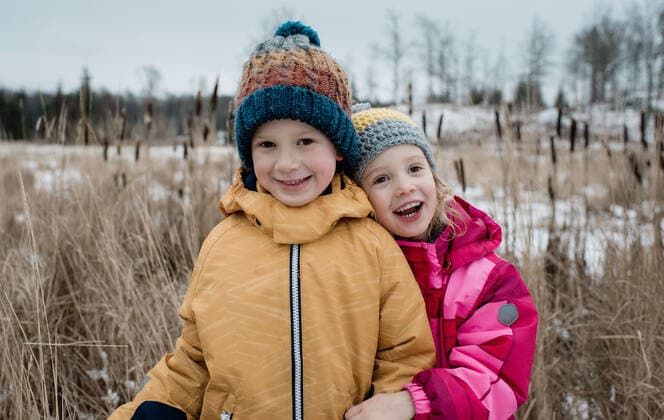 siblings cuddling and laughing whilst playing outside in winter NorrtoÂ¤lje, Stockholm County, Sweden ,model released, Symbolfoto CR_RABE200124-281126-01