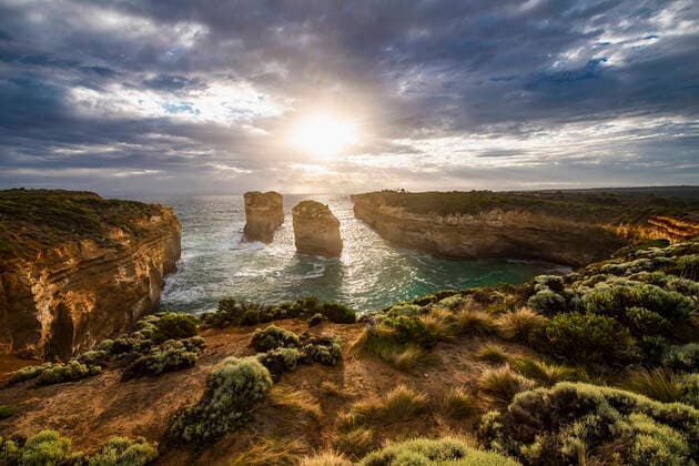 Tom and Eva look out on the Australian coast at the twelve apostles Port Campbell, VIC, Australia CR_THHE200128B-253180-01