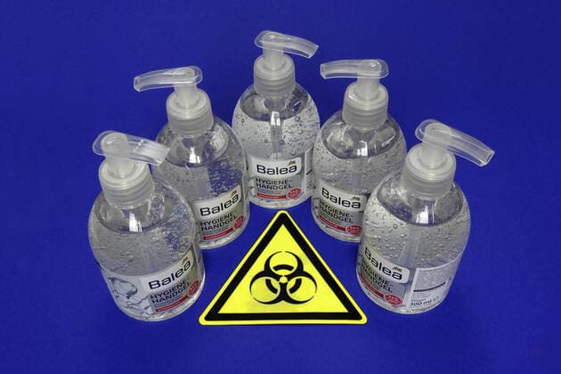 Hygiene hand gel and symbol of Biohazard Hygiene hand gel and symbol of Biohazard, 12 03 2020, Borkwalde, Brandenburg, In front of five bottles of hygiene hand gel lies the symbol of Biohazard