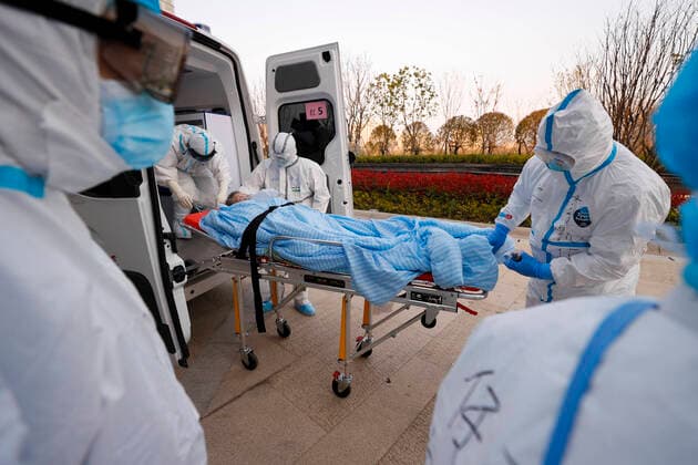 (200315) -- WUHAN, March 15, 2020 -- Medical transferring team members from Shanghai and Inner Mongolia transfer a patient with stretcher to a hospital in Wuhan, central China s Hubei Province, March 14, 2020. Since the novel coronavirus outbreak, 32 medical transferring teams from different provinces have rushed to Wuhan to fight at the frontline. Exposed to the danger of infection, they shuttle between hospitals and medical treatment stations around the clock to make sure that patients are transported to designated places in time. From Feb. 12 to March 10, a total of 7,343 infected patients, including 2,464 with severe symptoms, have been transferred. According Liu Yi, head of the Shanghai medical transferring team, his team ran approximately 20 trips to transfer over 100 patients a day during the hardest time. It s not easy.