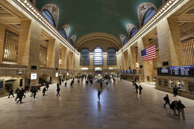 Commuters walk in a near empty Grand Central Station Terminal between 7:30 and 8 AM to start the week in New York City on Monday, March 16, 2020. Over a million New York City public school children are staying home Monday with the first day of closure of public schools in New York City. New York Mayor Bill De blasio is also signing an executive order Monday limiting restaurants to take-out only and shutting down bars and clubs that do not serve food.  NYP20200316111 JOHNxANGELILLO